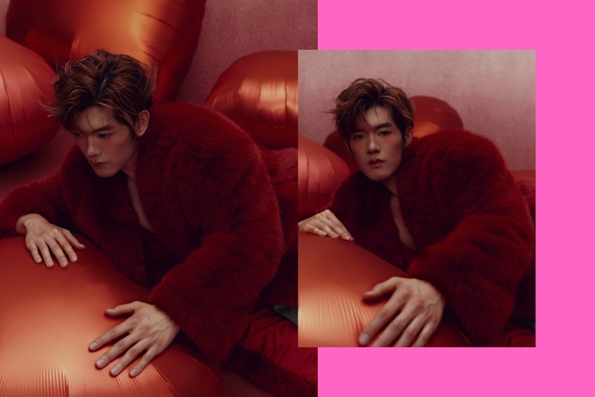 Aiden in a red padded plush coat by The Frankie Shop